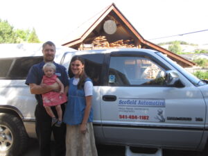 Jamin Scofield, founder of Scofield Automotive with his wife and son.