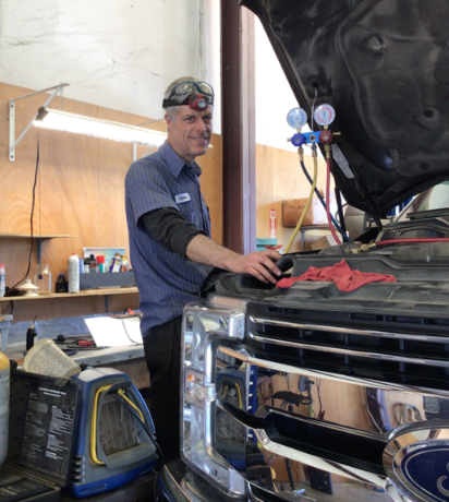 Dylan, one of the mechanics at Scofield Automotive repair in Roseburg and Green, OR working on a cars a/c