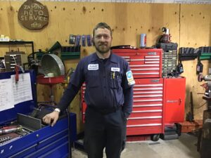 Picture of Jamin Scofield, owner of Scofield Automotive repair shop in Roseburg, OR - standing in the shop