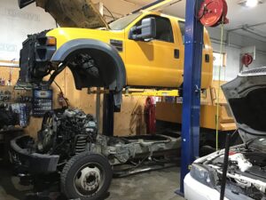 Image of a cab off a frame showing Scofield Automotive of Roseburg and Green OR working on a diesel engine