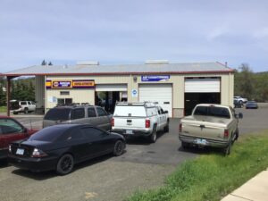 A view of Scofield Automotive repair shop of Roseburg and Green, OR, from the sidewalk.