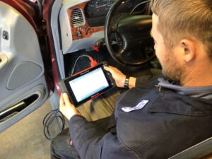 Jamin Scofield of Scofield Automotive using an auto diagnostic scan tool